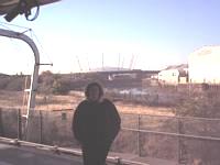 A huge white dome shaped structure with spikes coming out of the top and the MILLENNIUM DOME